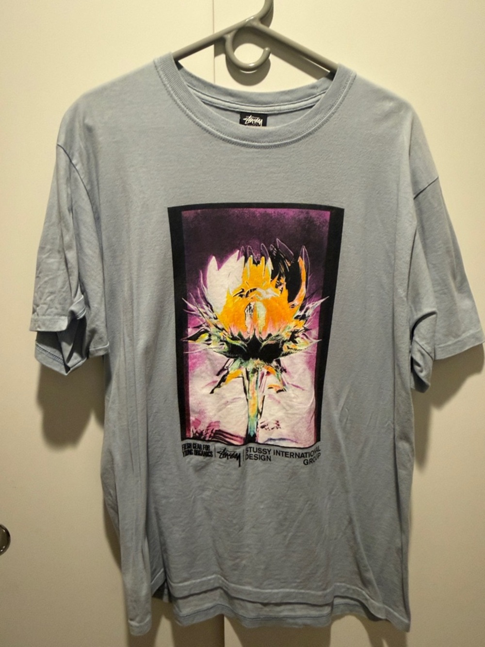Stussy Light Blue Tee with Yellow & Purple Floral Graphic
